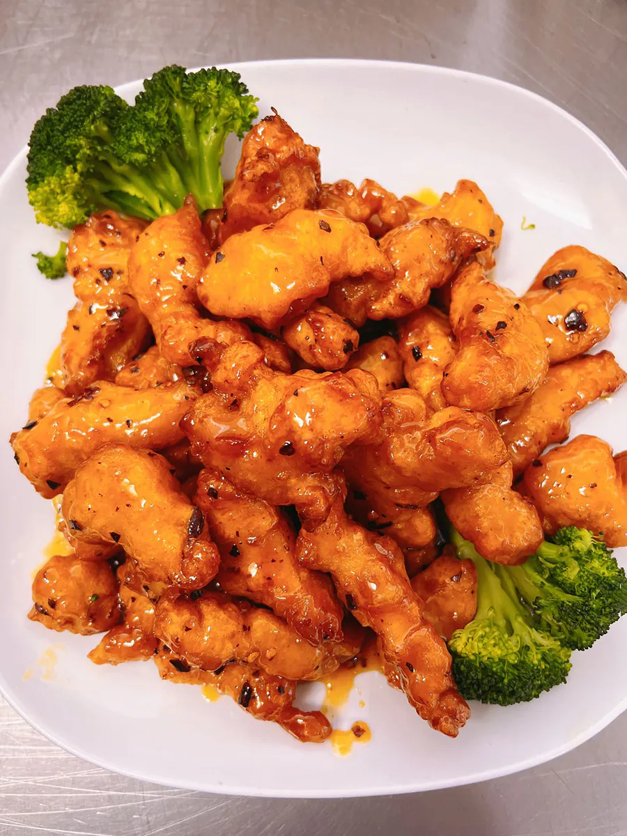 Plate of orange chicken with broccoli at Eggroll Inn，a American Chinese Restaurant in Balch Springs