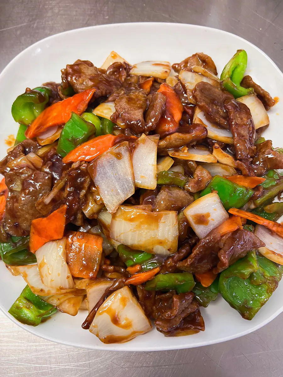 Stir - fried chicken with gai lan at Eggroll Inn，a American Chinese Restaurant in Balch Springs